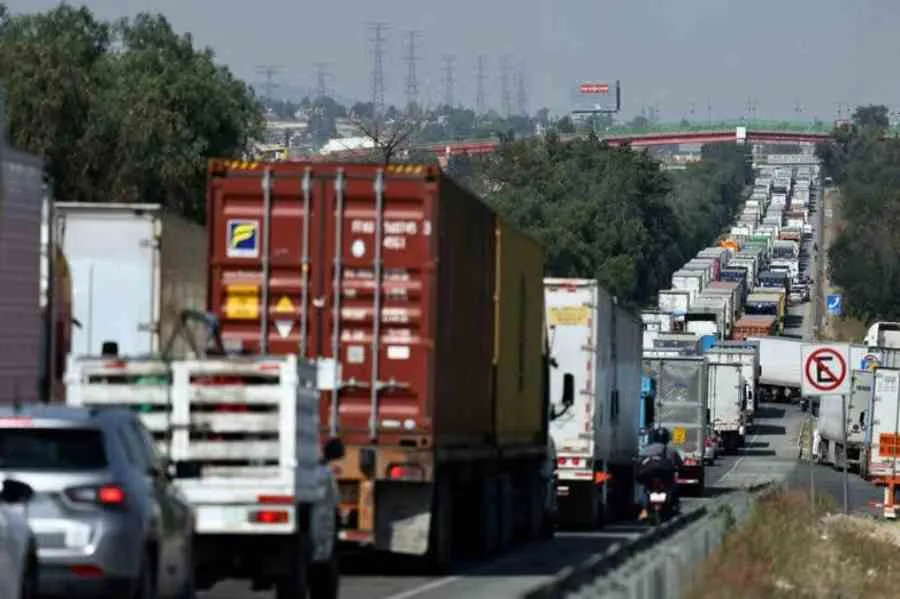 Transport workers and vehicles blocking a highway during protests in Mexico