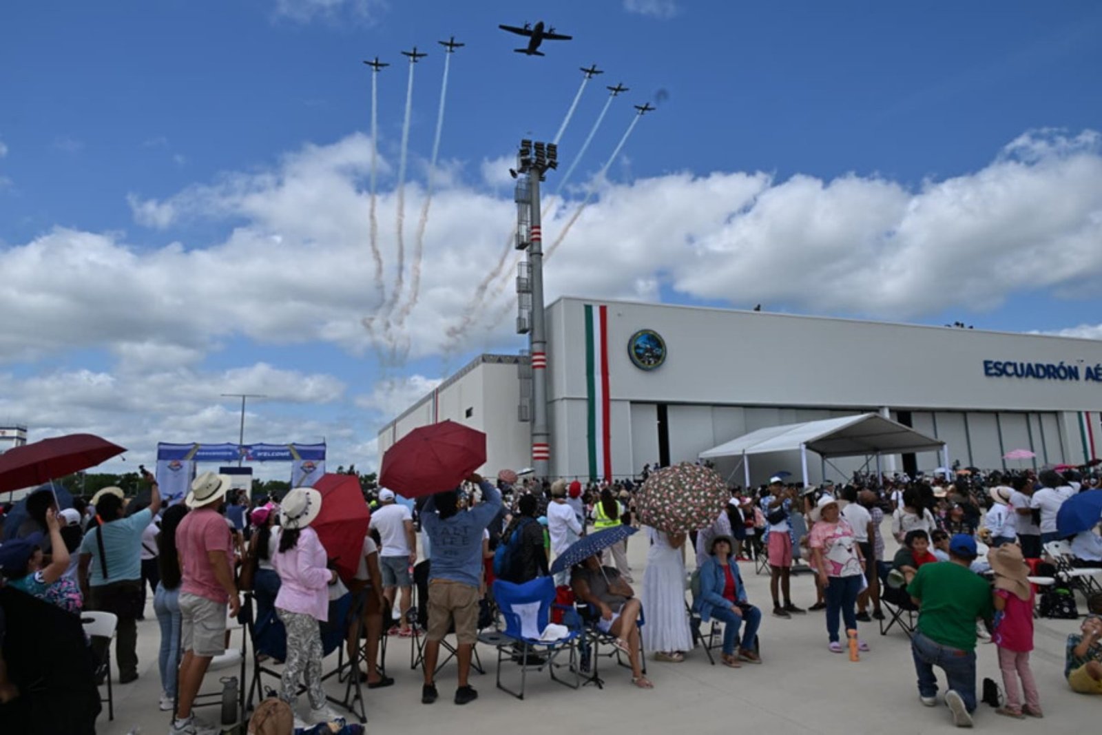 Aerial display at Tulum Air Show 2026 with military aircraft over runway