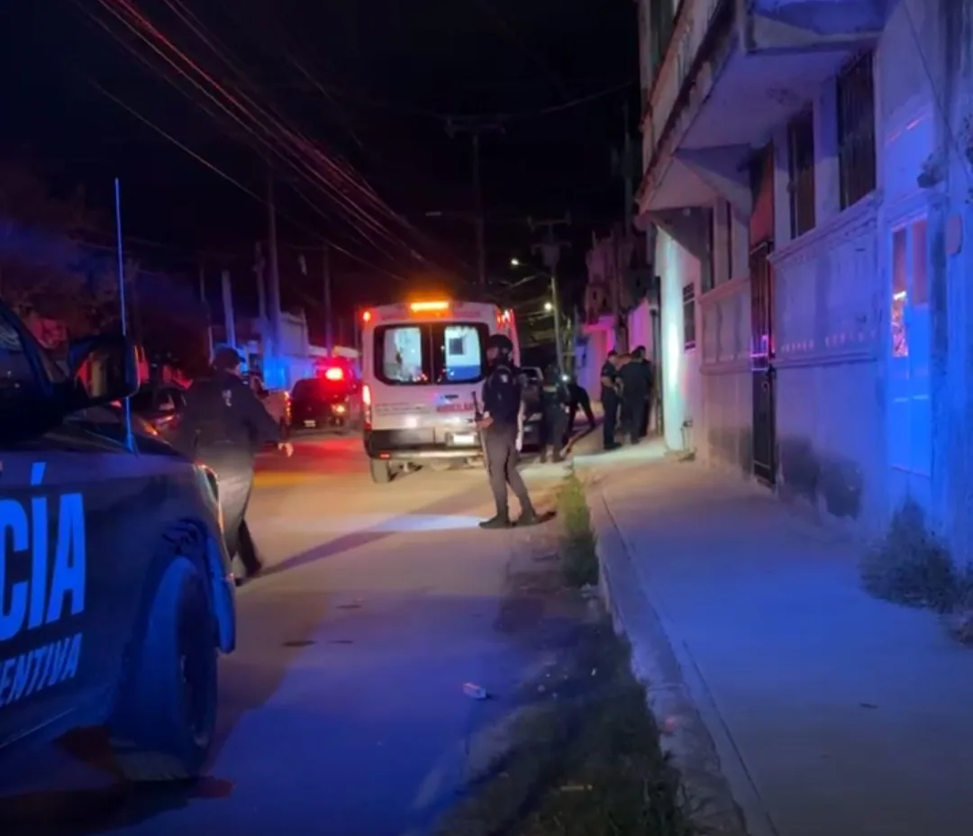 Police vehicles and officers responding to a shooting incident in Tulum's Maya neighborhood