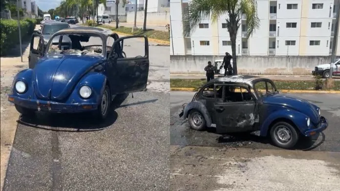 A Volkswagen Beetle engulfed in flames on a residential street in Playa del Carmen