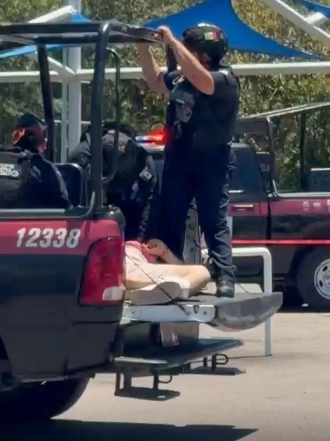 Police and emergency vehicles at the scene of a shooting in a Walmart parking lot in Chetumal, Quintana Roo