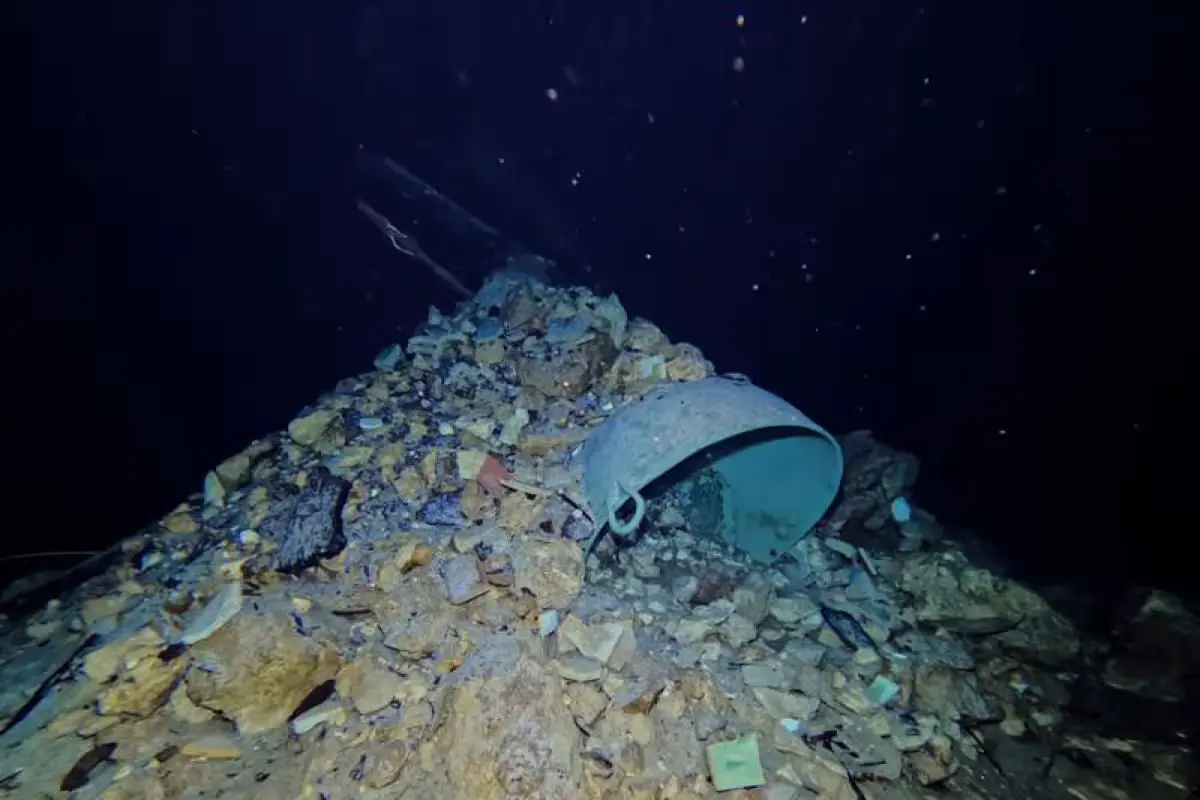 Archaeological divers document muskets and a cannon submerged in the dark waters of the Sii's Ja cenote under the San Bernardino de Siena convent in Valladolid, Yucatan.