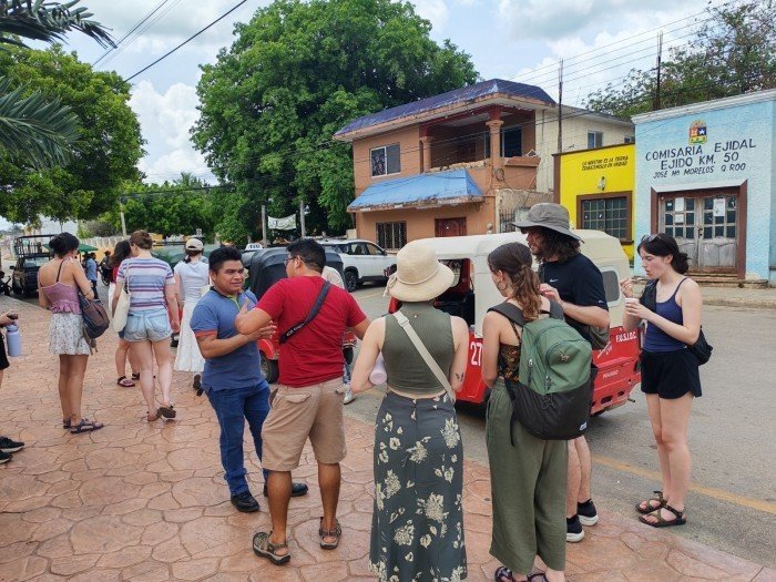 Group of Canadian university students posing with local Maya community members in Quintana Roo