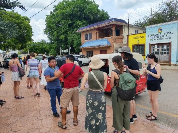 Group of Canadian university students posing with local Maya community members in Quintana Roo