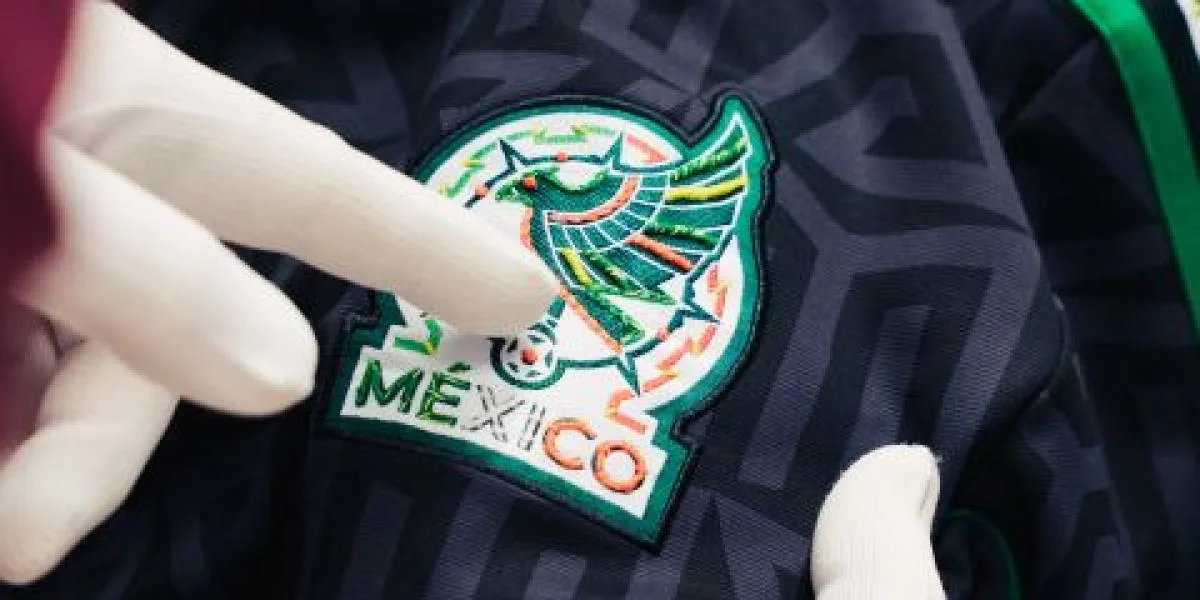 A hand-embroidered lifestyle jersey from the Adidas and Someone Somewhere collection, featuring floral details and the Mexican Football Federation crest.