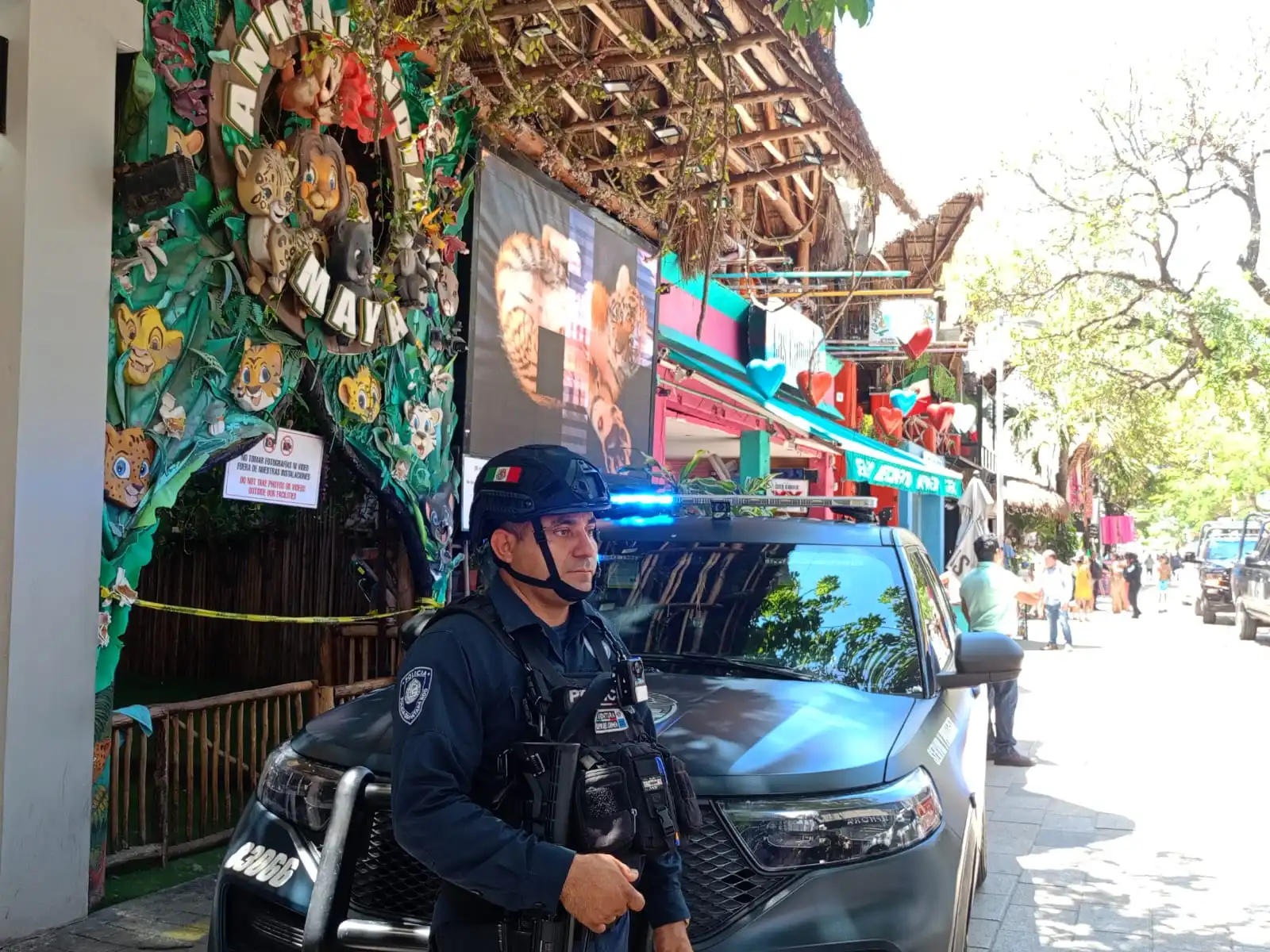 Police and officials outside Animalandia Maya exotic animal store during a raid in Playa del Carmen