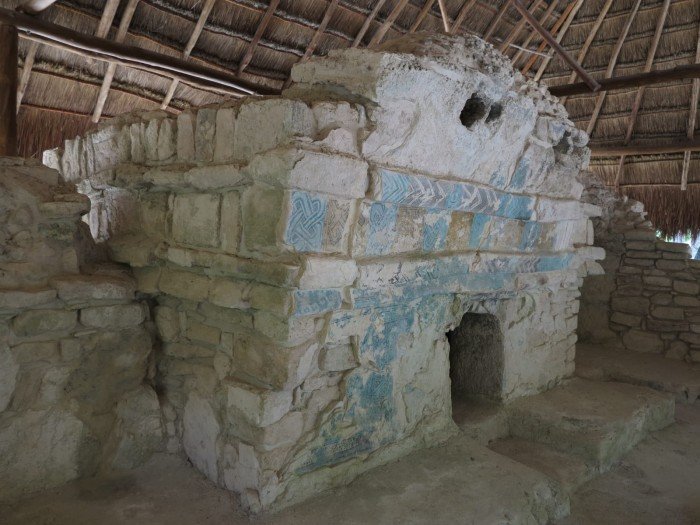 Ancient stone structures among trees at an archaeological site in Playa del Carmen, Quintana Roo