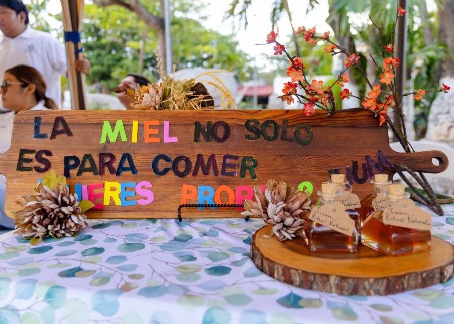 People gather at the Bee Festival in Tulum, Quintana Roo, with educational exhibits and honey products.