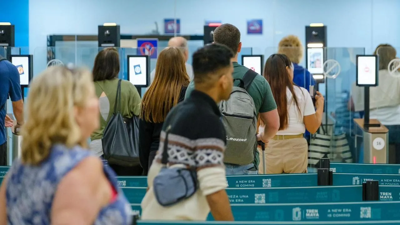 Passengers at Cancun International Airport immigration area with new biometric e-gates
