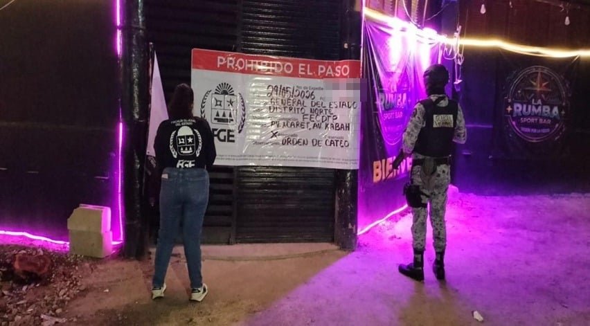 Police officers outside a bar in Cancun during a raid that rescued 18 women from human trafficking and forced prostitution