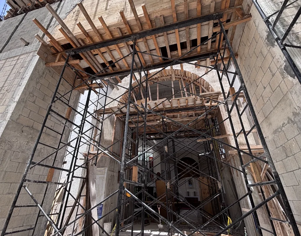 Construction of the new Cancun Cathedral with a partially built bell tower and scaffolding