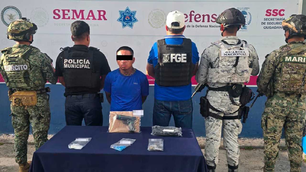 Police officers detain a suspect in Cancun during the Blindaje Cancun operation