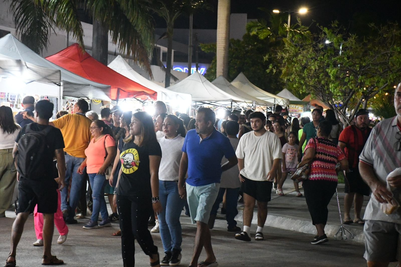 Crowd at the Feria del Queso de Bola in Chetumal with food stalls and banners