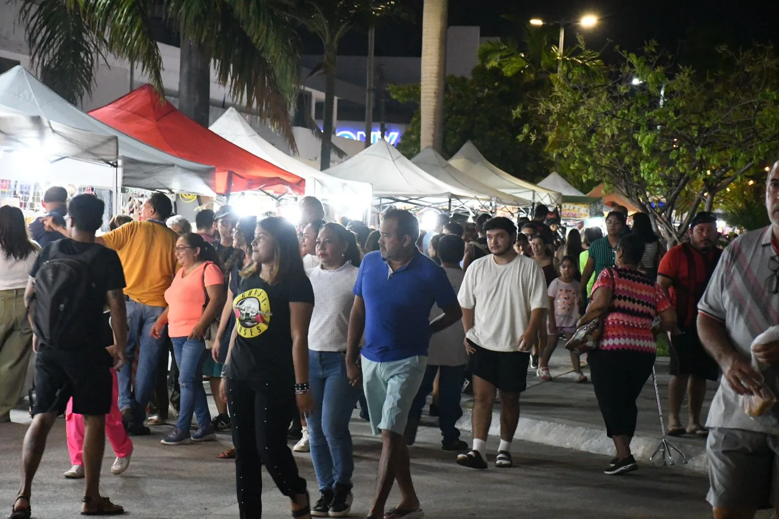Crowd at the Feria del Queso de Bola in Chetumal with food stalls and banners