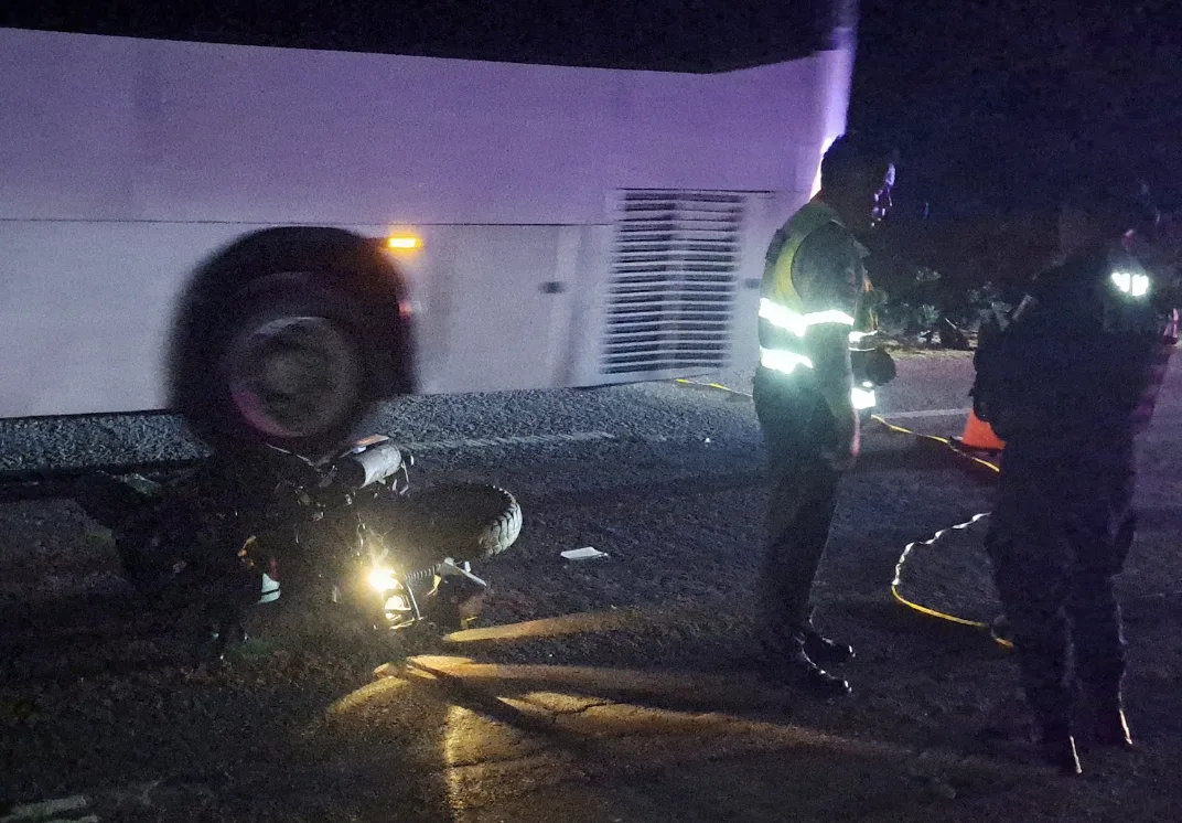 A damaged motorcycle and car at the scene of a hit-and-run accident on Highway 307 near Tulum
