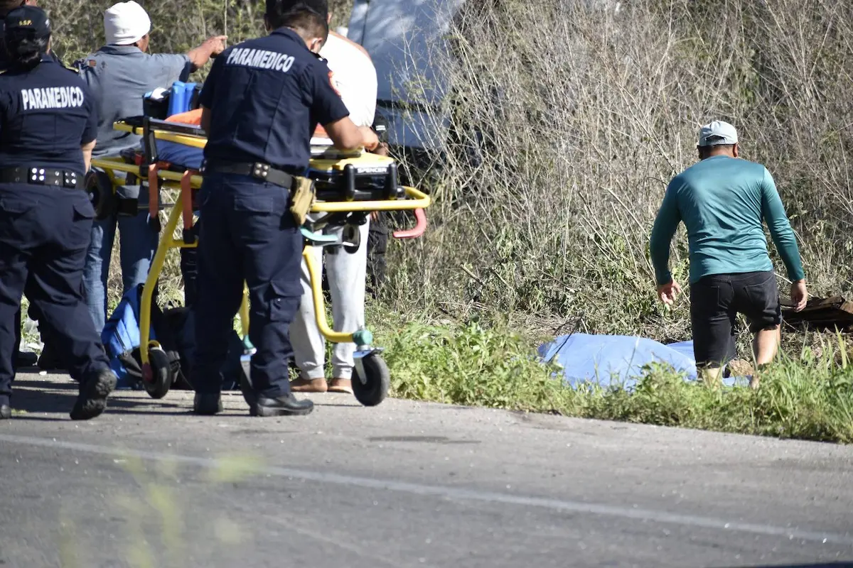 Emergency responders at the scene of a fatal crash on the Merida-Cancun highway near Seye, Yucatan