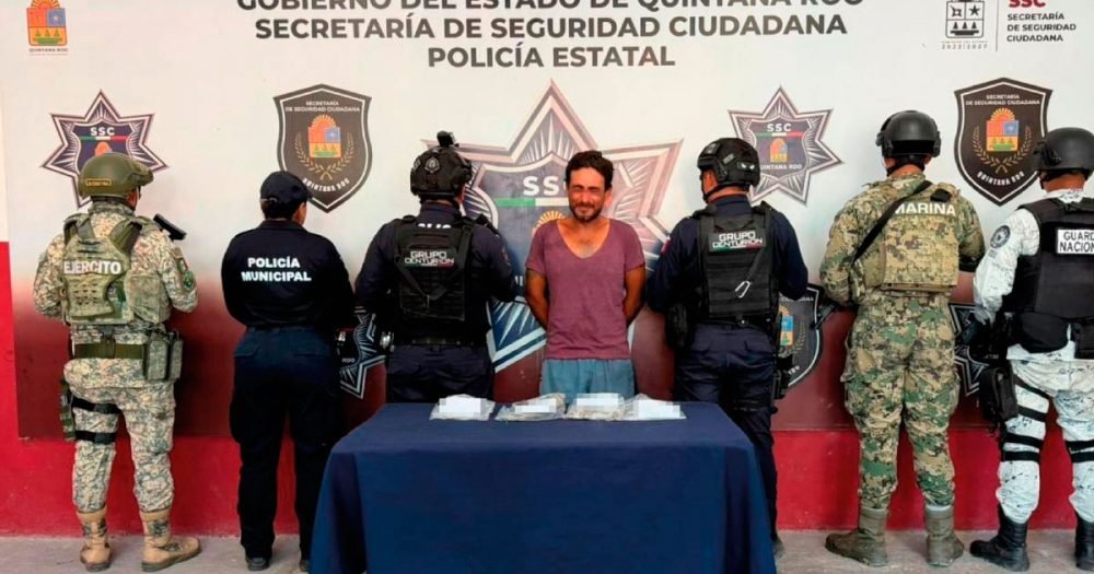 Police officers holding evidence bags containing drugs during an operation in Quintana Roo