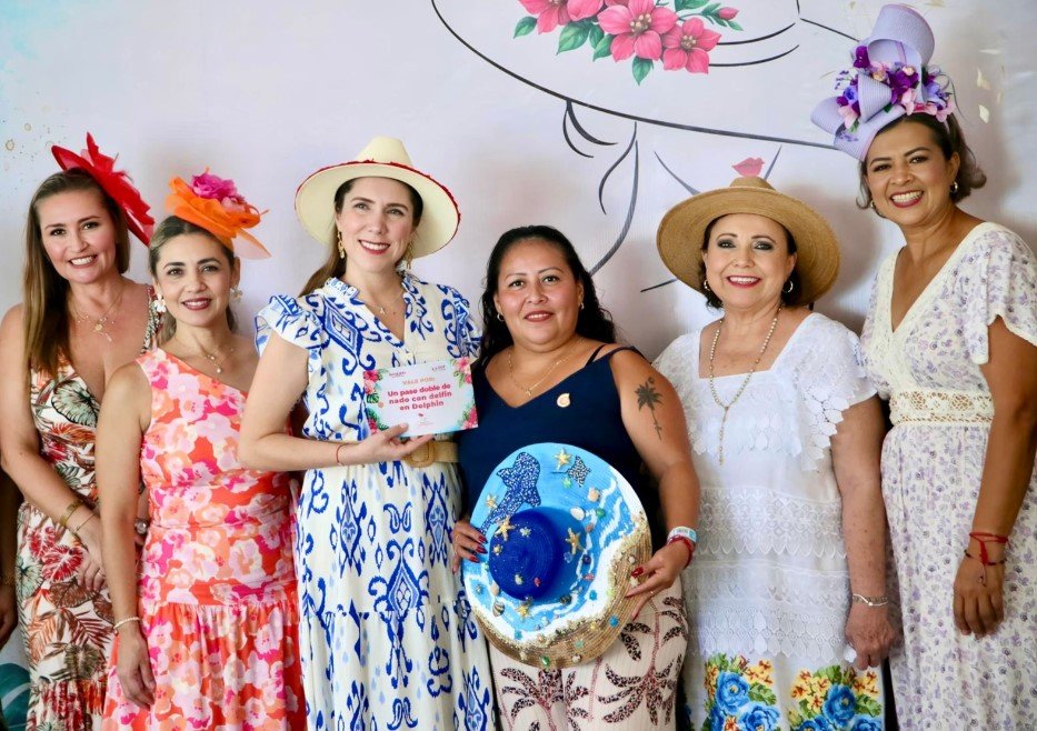 Women wearing creative hats at the Desayuno del Sombrero charity breakfast in Isla Mujeres