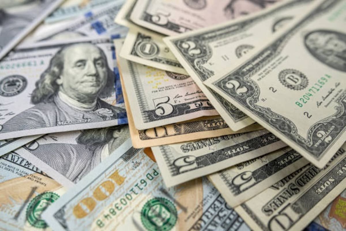 US dollar and Mexican peso banknotes arranged on a table representing currency exchange