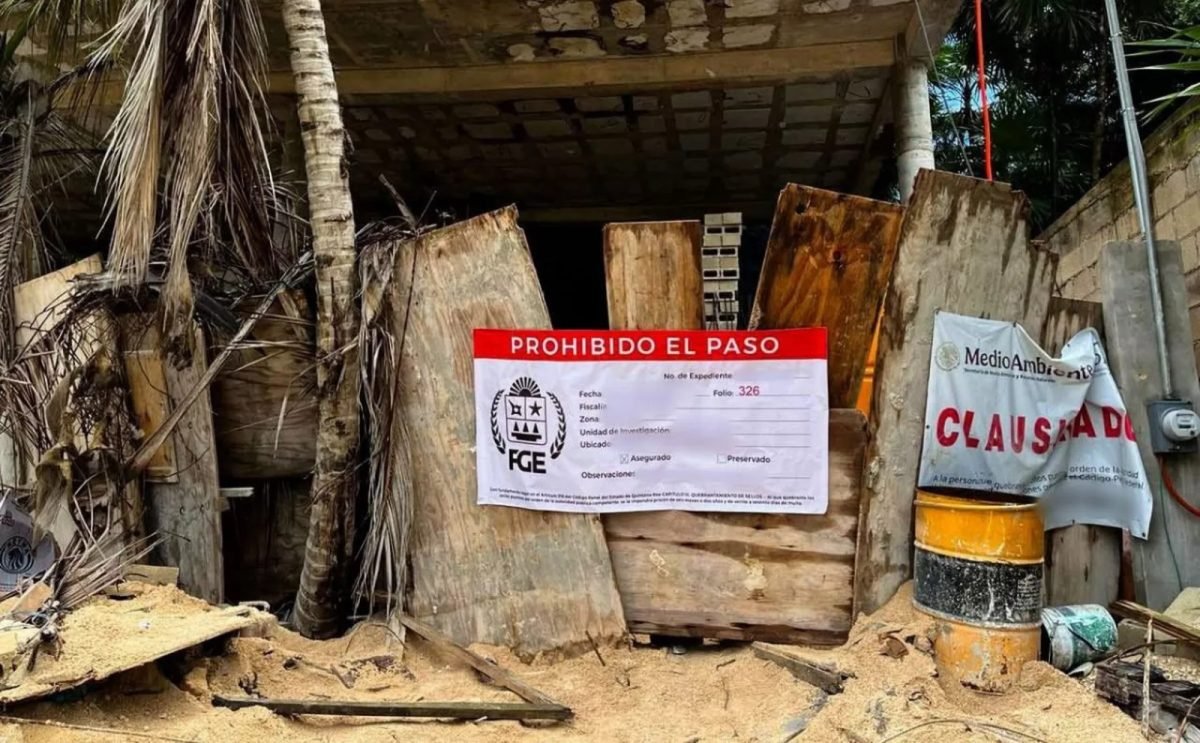 An elderly homeless person sitting on a sidewalk in Cancun, surrounded by belongings