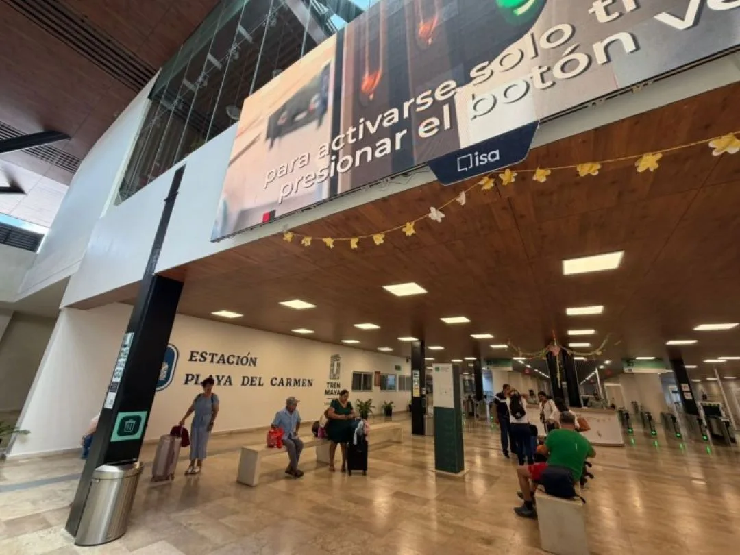 Nearly empty interior of a Maya Train station in Quintana Roo showing few passengers and vacant commercial spaces