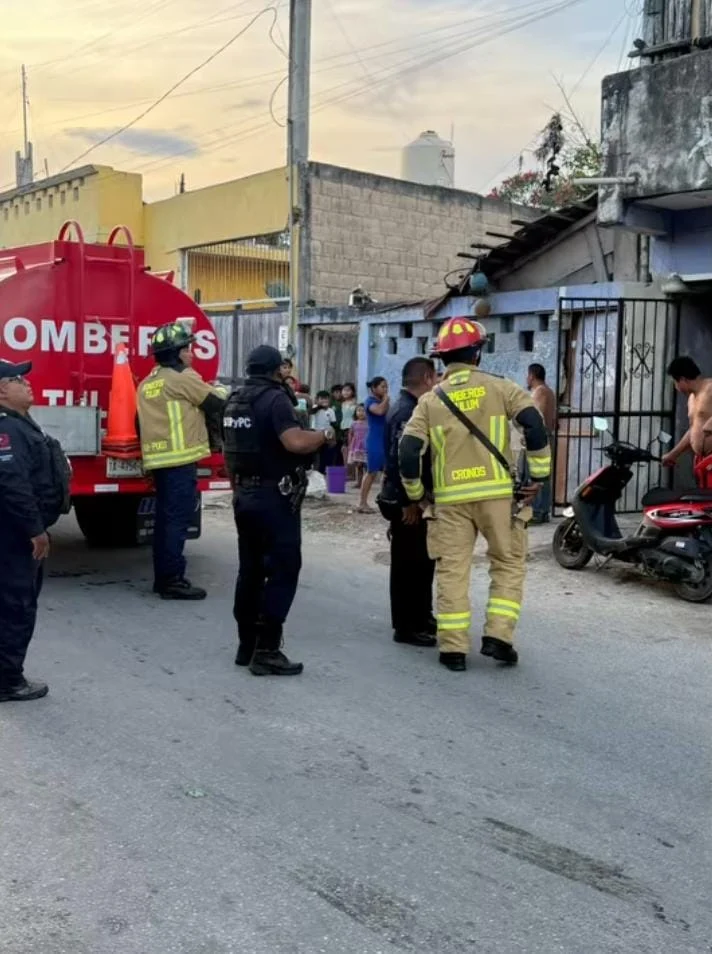 Emergency responders at the scene of a firebomb attack on a rooming house in Tulum, Quintana Roo
