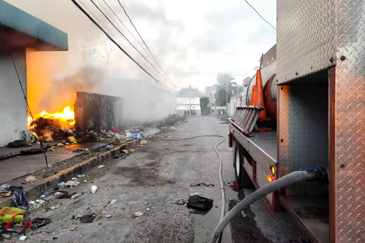 Firefighters working to extinguish a fire at the abandoned General Hospital in Cancun, with smoke billowing