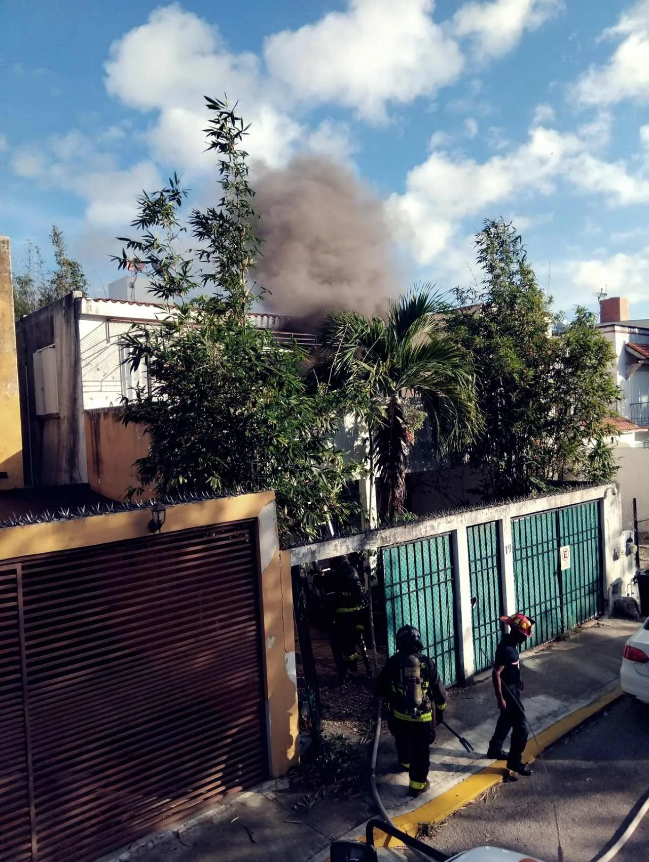 Firefighters and emergency personnel at the scene of a house fire in Playa del Carmen's Santa Fe neighborhood