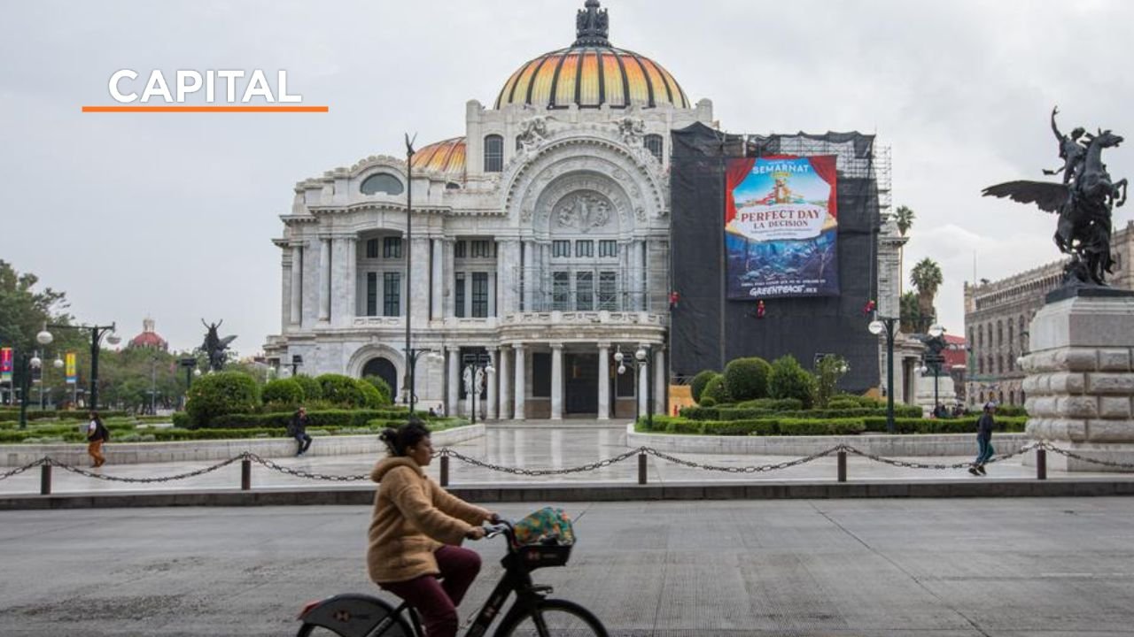 Greenpeace activists hang a protest banner on scaffolding at the Palace of Fine Arts in Mexico City