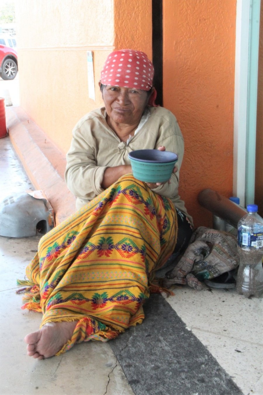 A homeless woman sitting on a bench in Playa del Carmen, Quintana Roo, Mexico