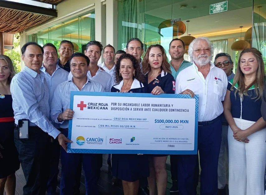 Representatives of the Cancun hotel association handing a donation check to Red Cross officials