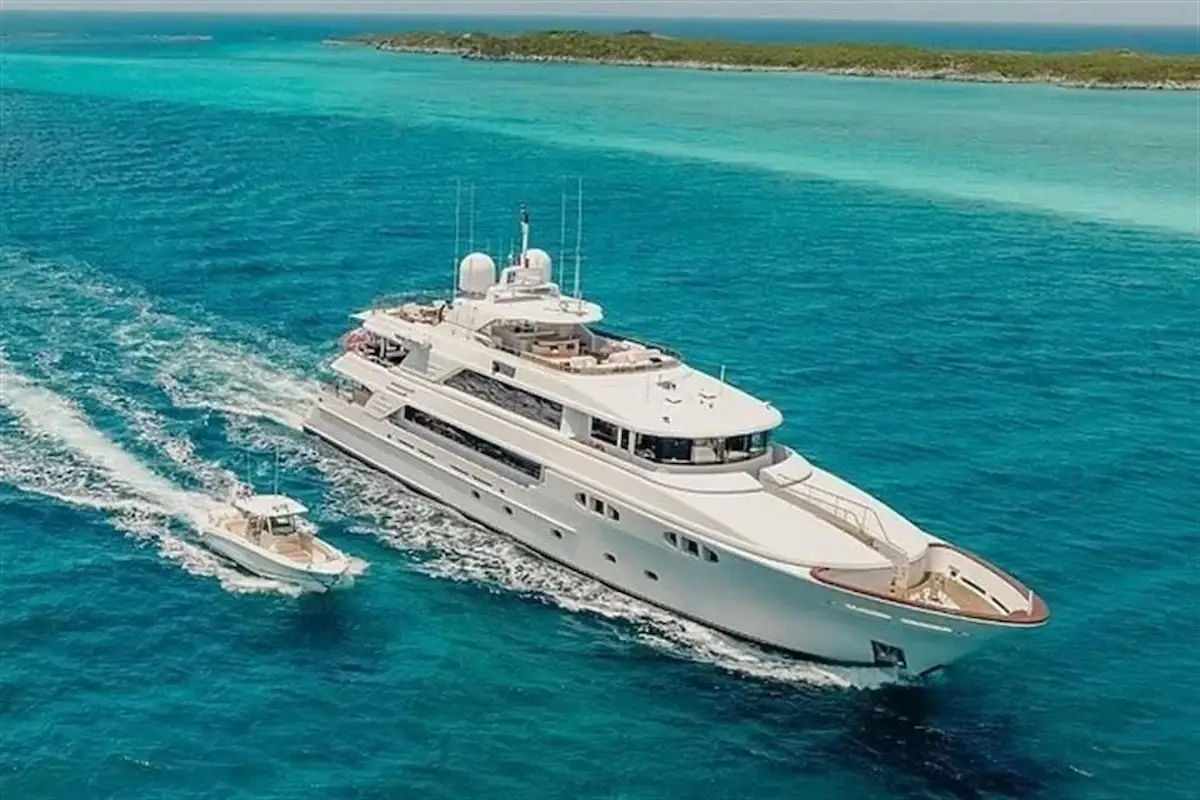 A large luxury yacht anchored in turquoise waters, representing high-emission recreational vessels targeted by the proposed tax.