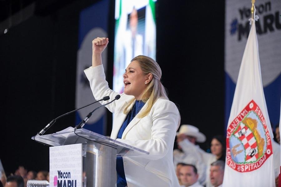 Chihuahua Governor Maru Campos speaking at a PAN rally with party leaders behind her