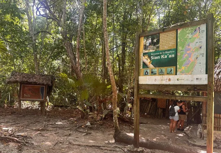 Mayan community members in traditional attire discussing cultural heritage