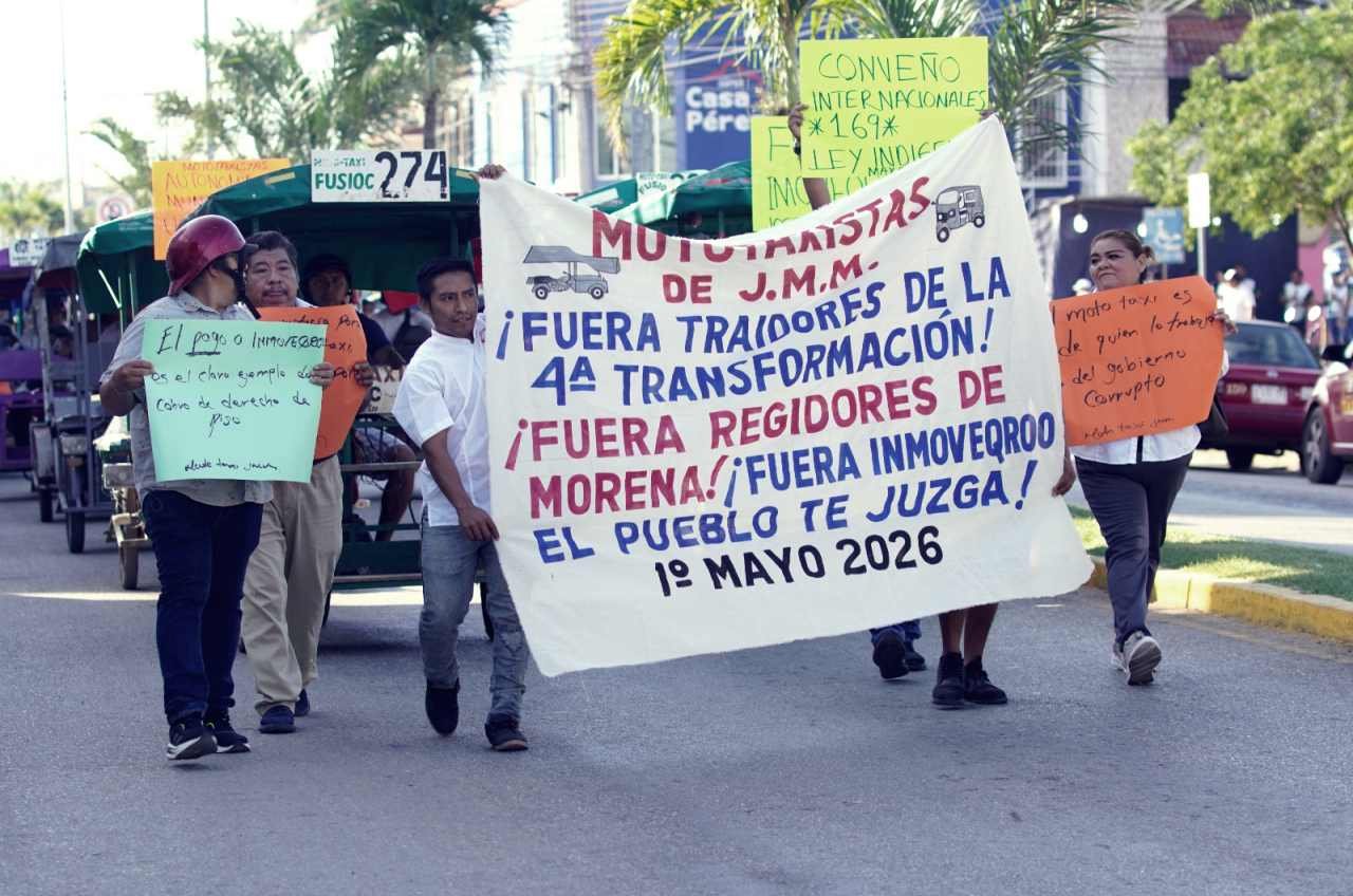 Mototaxi drivers on their vehicles holding signs during a protest in Jose Maria Morelos, Quintana Roo