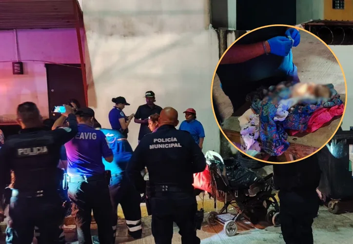 A newborn baby wrapped in a blanket being held by a rescuer