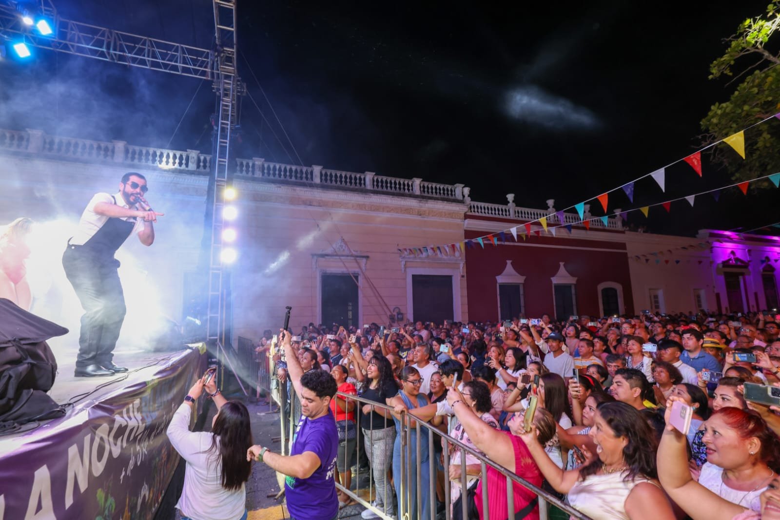 Large crowd gathered at a nighttime outdoor concert during La Noche Blanca festival in Merida, Mexico