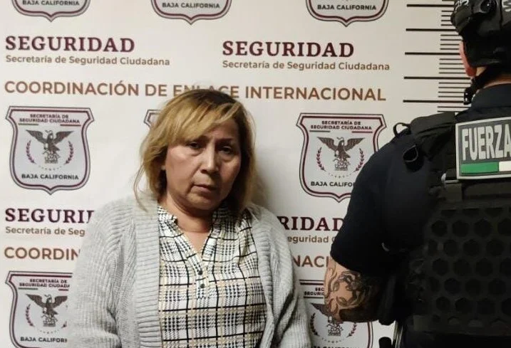 Mugshot of Ofelia Hernández Salas, a 64-year-old woman in a checked blouse and beige sweater