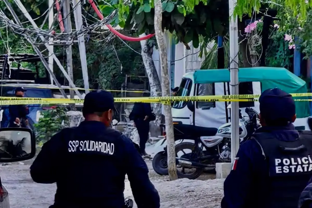 Paramedics providing first aid to a wounded mototaxi driver on a street in Playa del Carmen