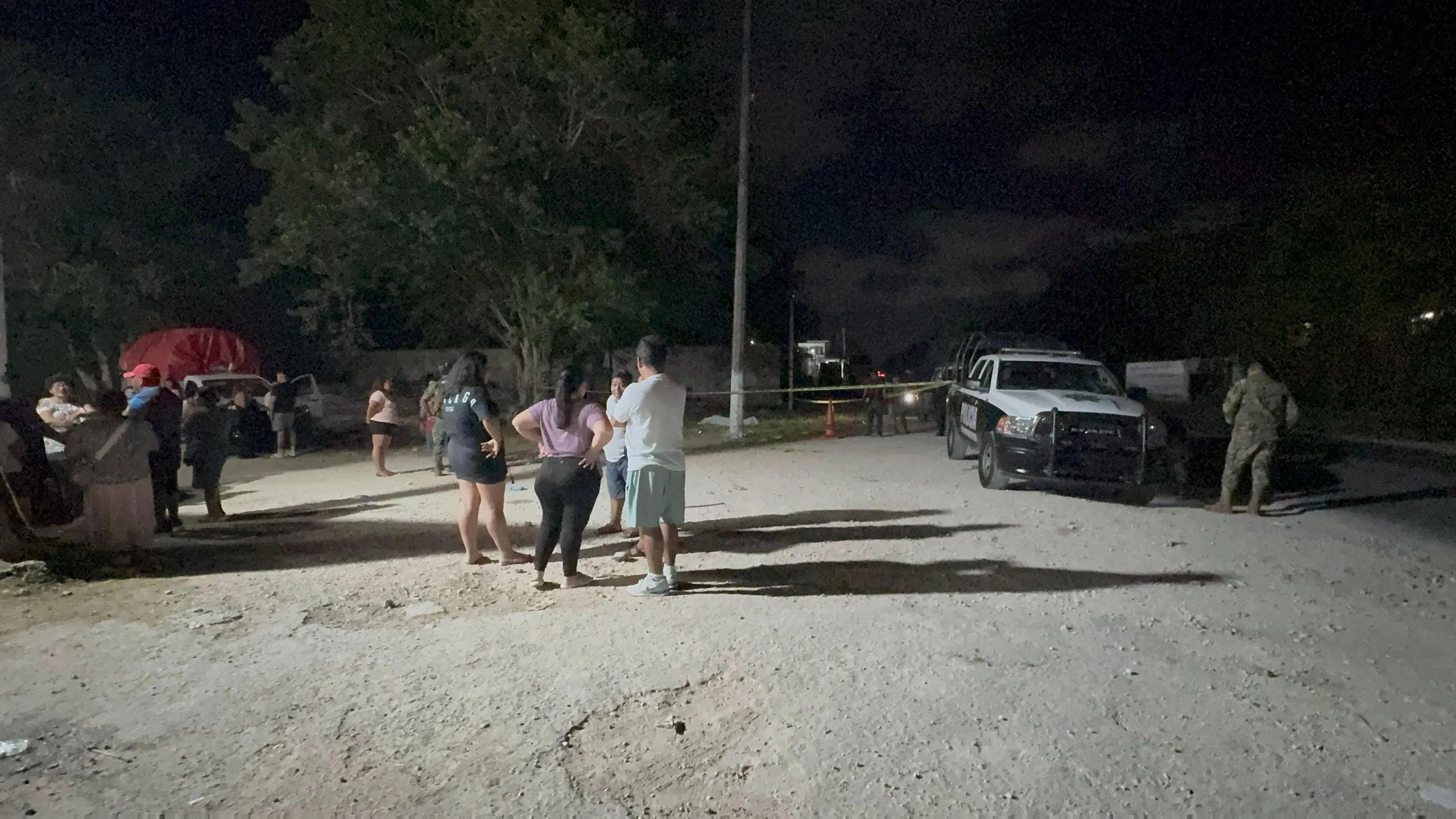 Police officers and crime scene tape outside the Tianguistas Verdes hall in Cancun after a fatal incident