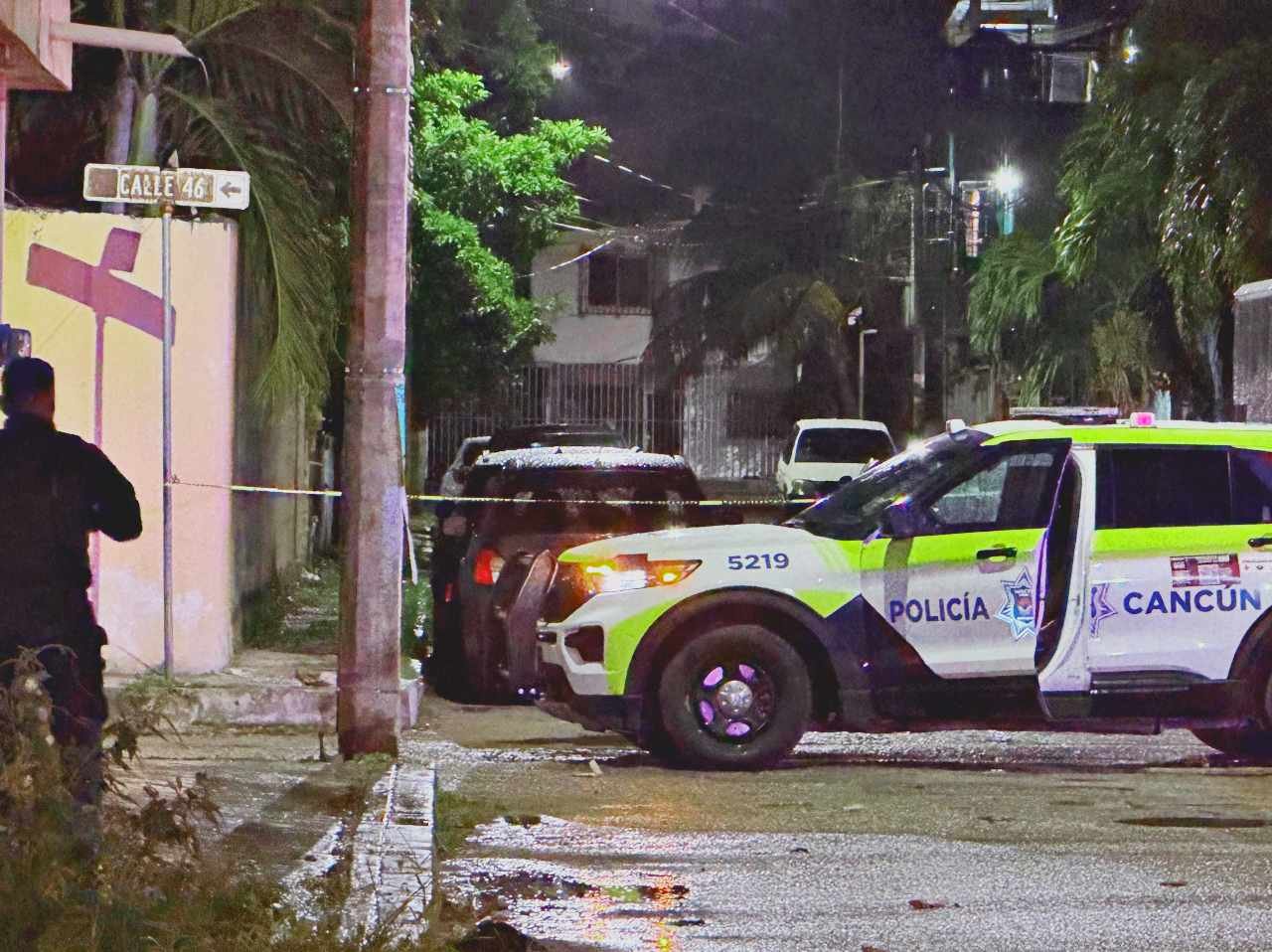 Police officers and military personnel at the scene of a shooting on a home in Cancun's Supermanzana 75 neighborhood