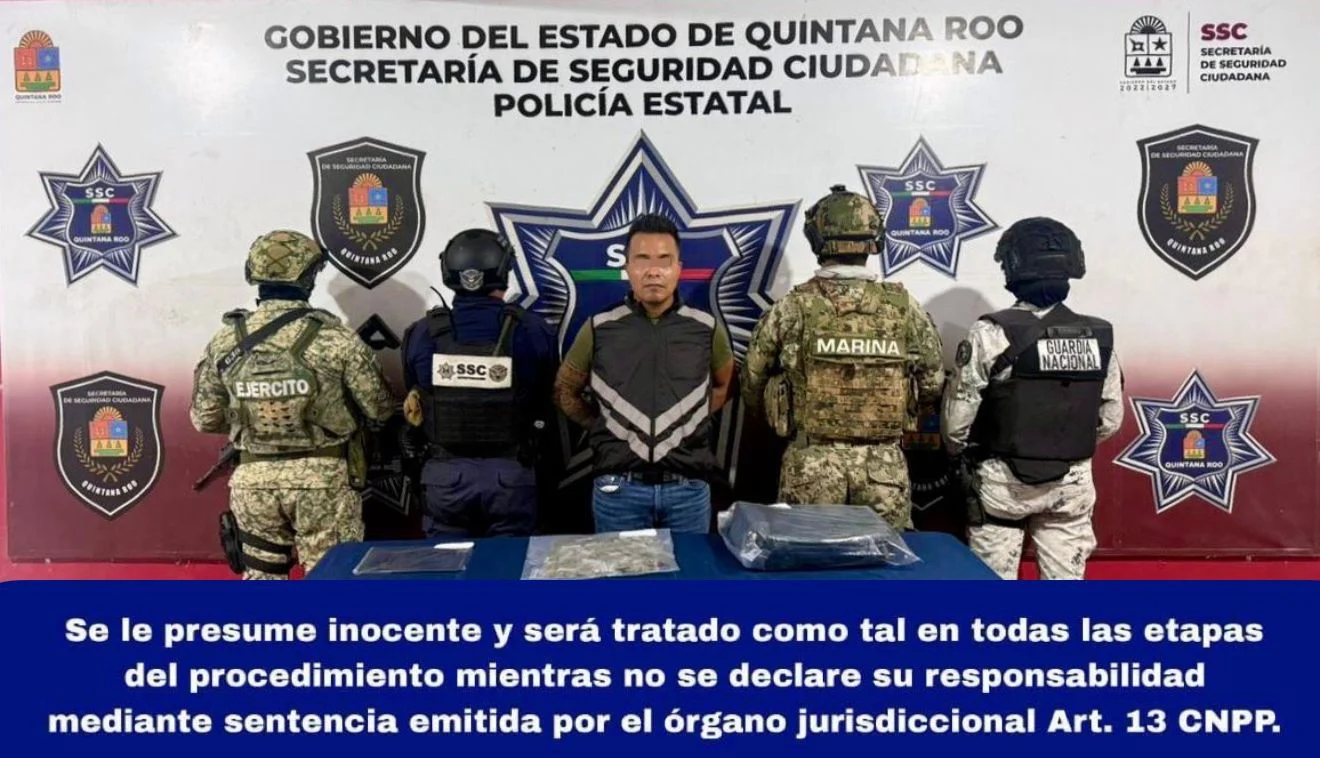 Police officers inspecting bags of marijuana and crystal meth seized during a traffic stop on the Puerto Morelos-Cancun highway.