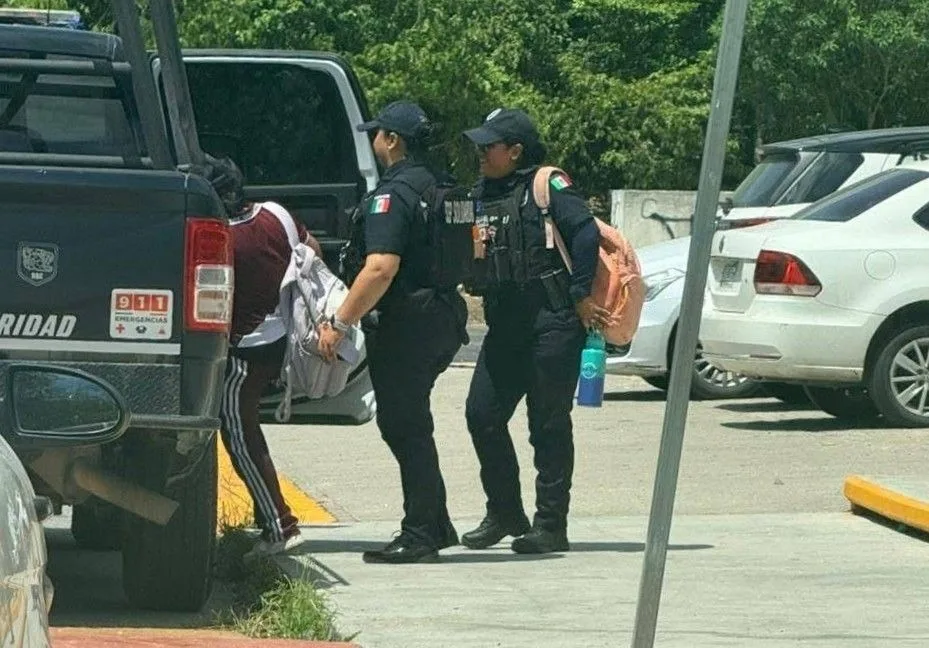 Police vehicles and officers outside the Vicente Guerrero middle school in Playa del Carmen after two students were found with drugs.