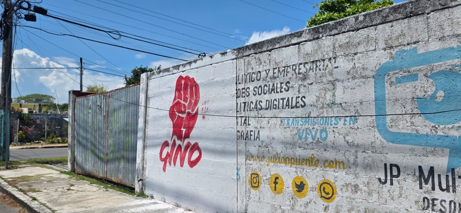 Photograph showing political propaganda painted on a wall and urban furniture in Chetumal, Quintana Roo