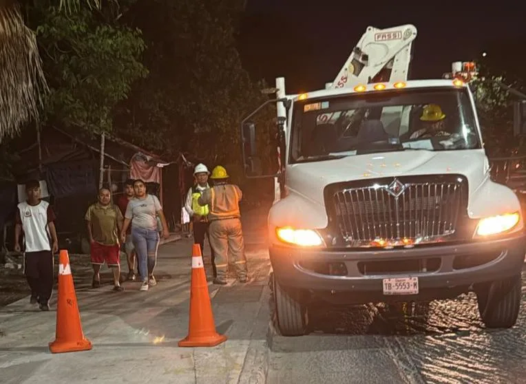 Residents in a darkened Playa del Carmen neighborhood during a power outage