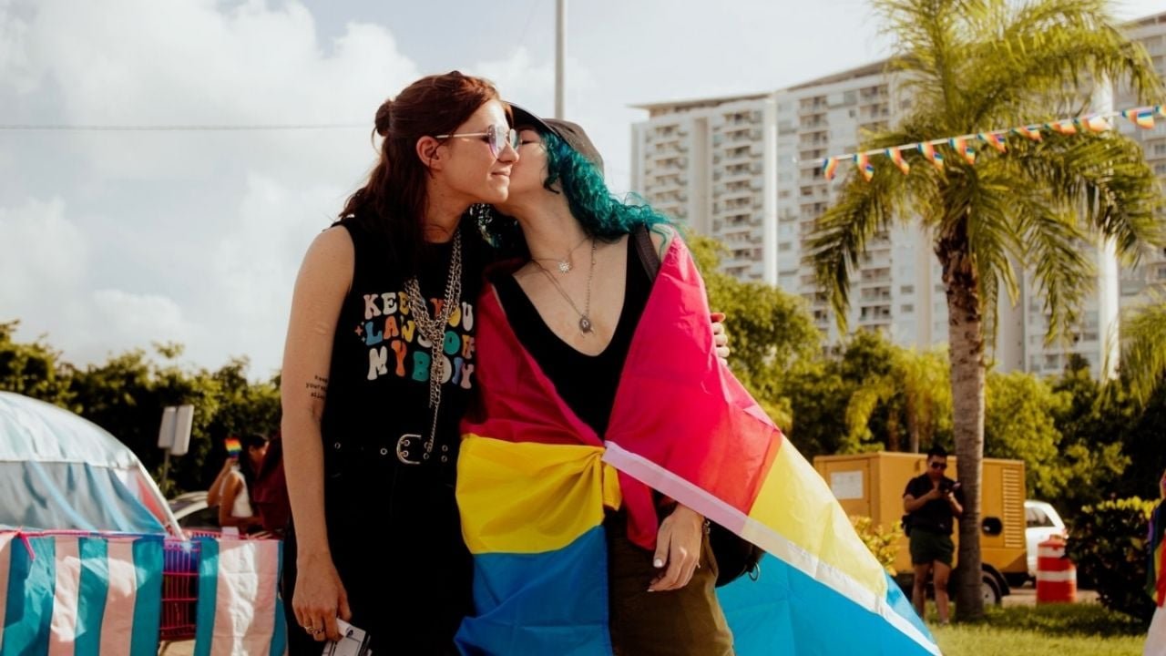 Pride flag and documents representing gender identity change campaign in Cancún