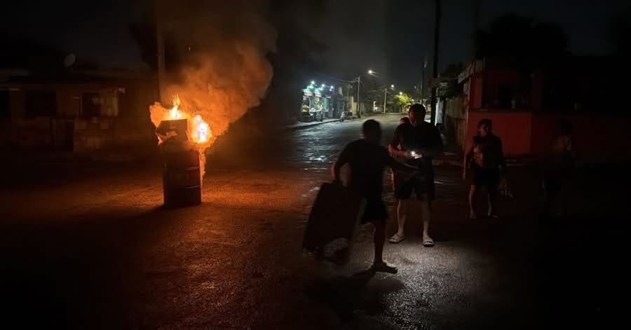 Residents block a street in Merida, Yucatan, protesting prolonged power outages.