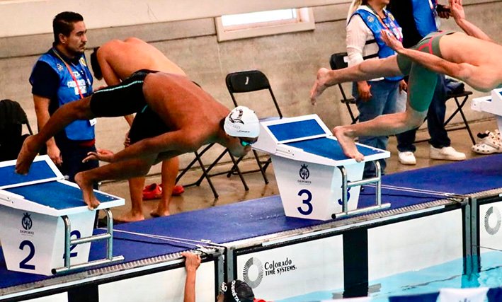 Quintana Roo athletes Iker Galindo and Anabel Hernandez with their gold medals at the Conade National Olympics swimming competition
