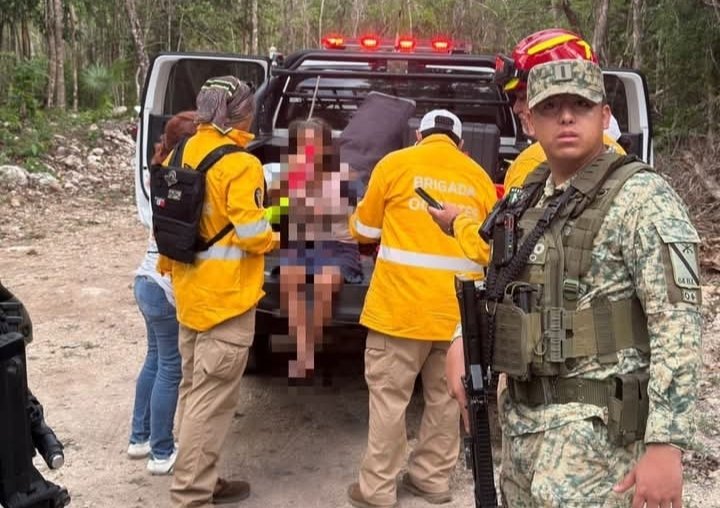 Emergency personnel assisting an elderly woman found in a jungle area near Playa del Carmen