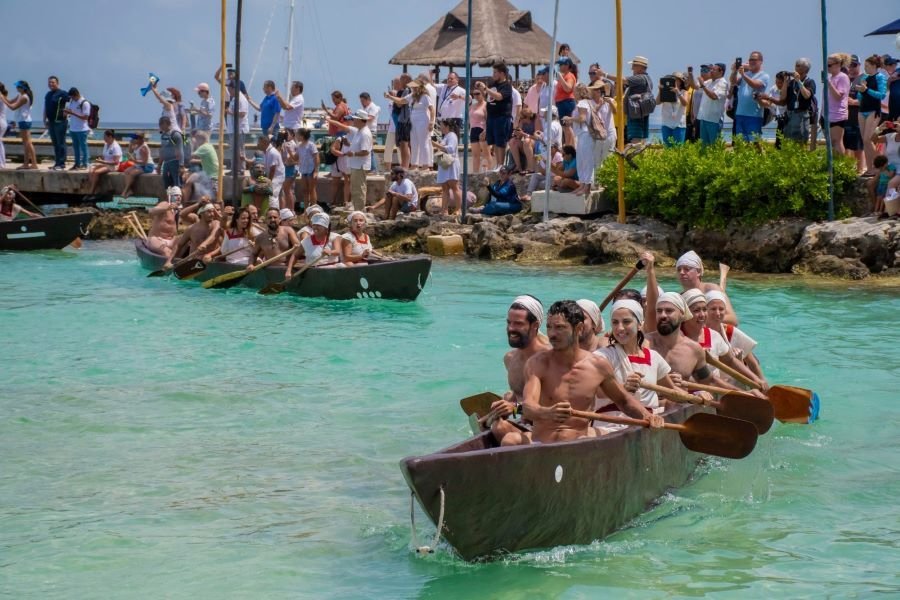 Participants in the Sacred Maya Journey, a traditional Maya canoe crossing organized by Grupo Xcaret in Cancun